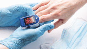 Close-up of a medical professional using a pulse oximeter to check a patient's oxygen saturation